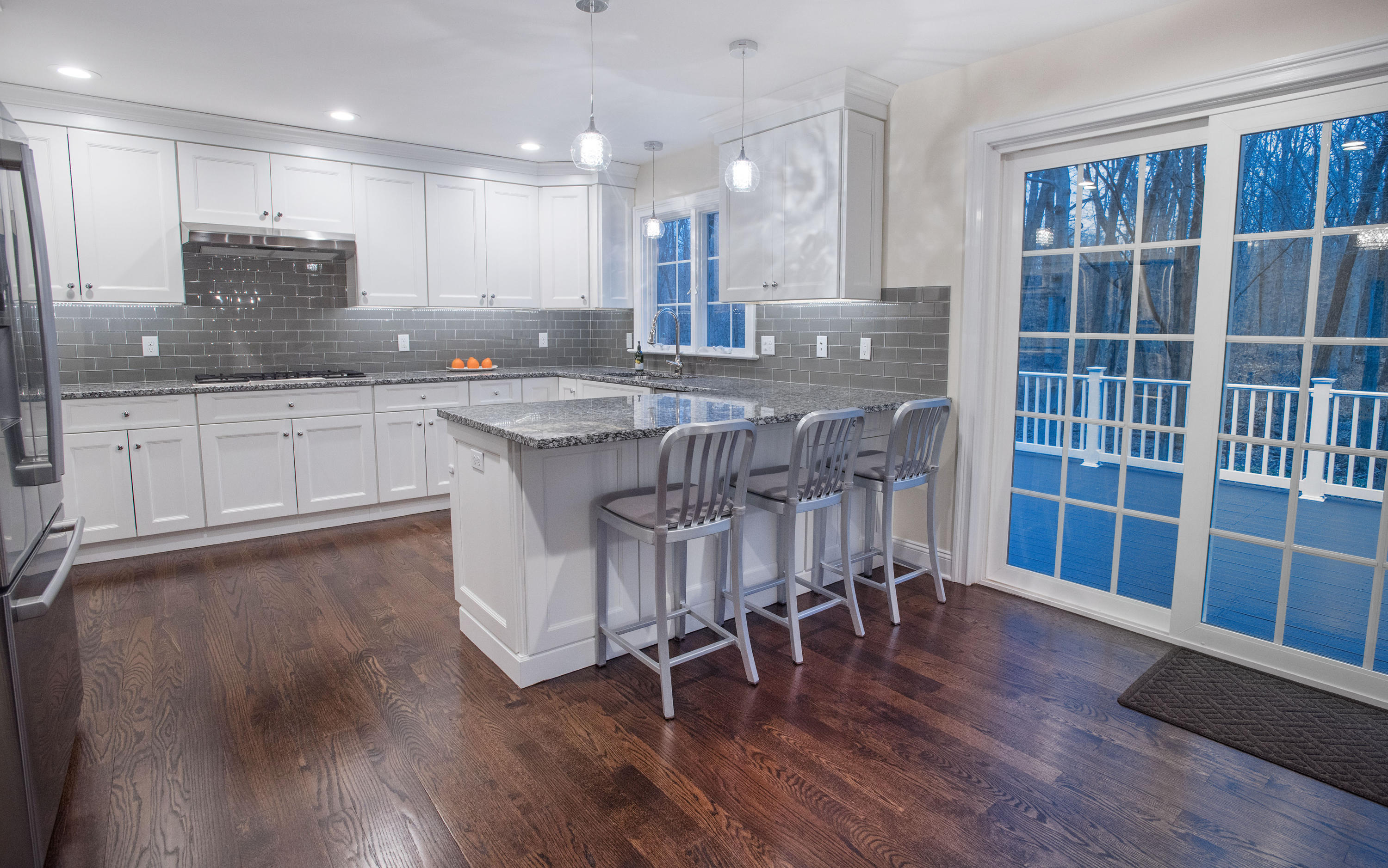 301 Quarry Road Stamford, CT 06903 - Photo 3 of 32 a kitchen with stainless steel appliances granite countertop a table chairs sink refrigerator and cabinets