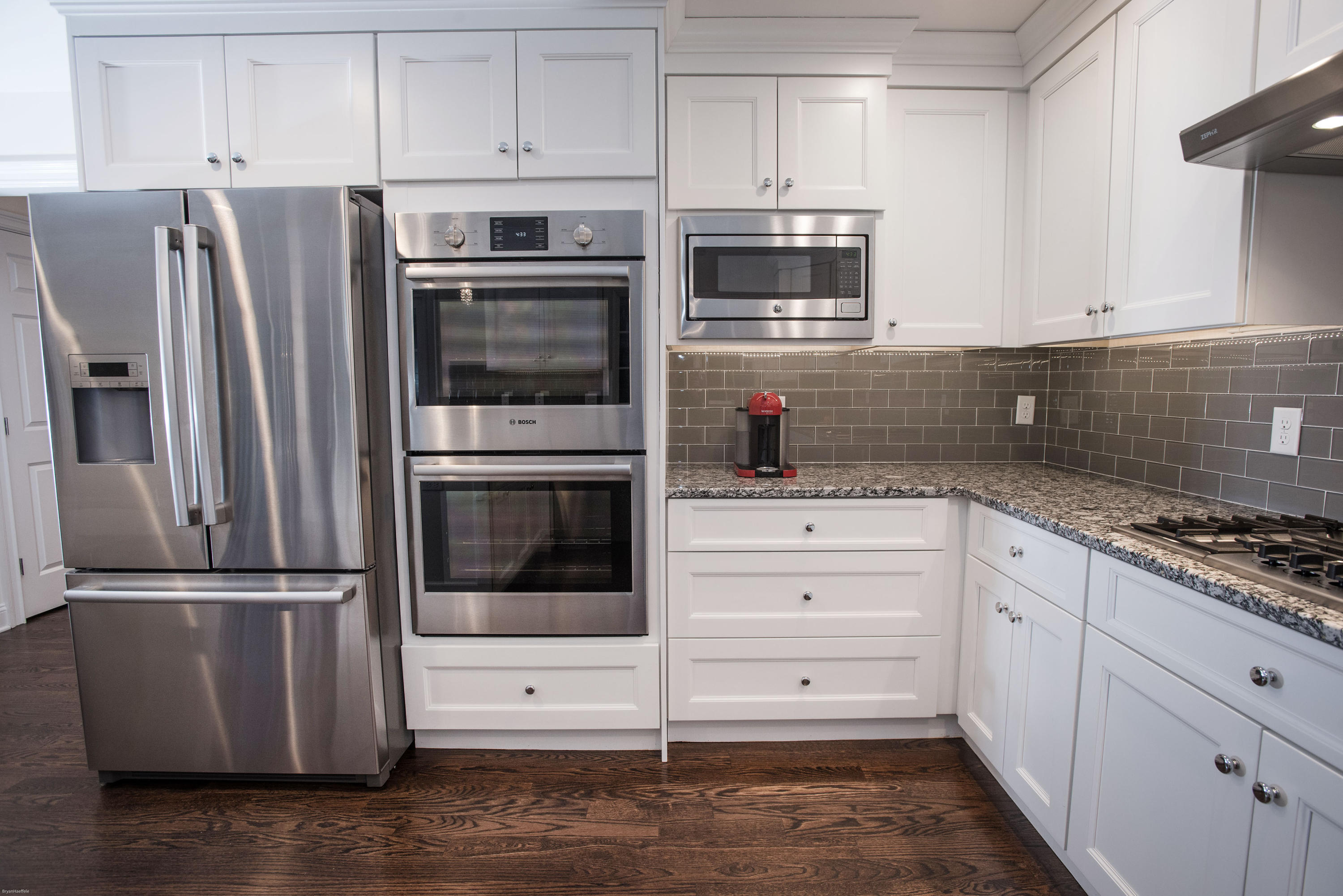 301 Quarry Road Stamford, CT 06903 - Photo 4 of 32 a kitchen with granite countertop white cabinets and stainless steel appliances