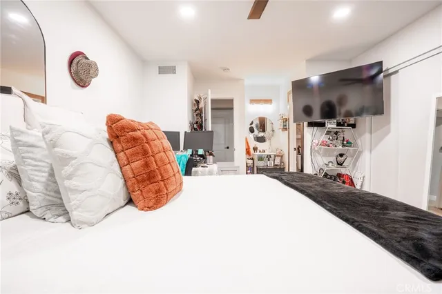 a bed room with a bed and a flat screen tv