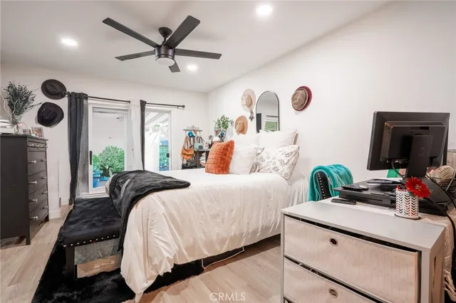 a bedroom with a bed and a dresser with mirror