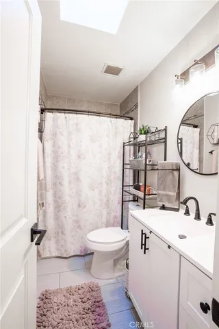 a bathroom with a sink toilet and a mirror