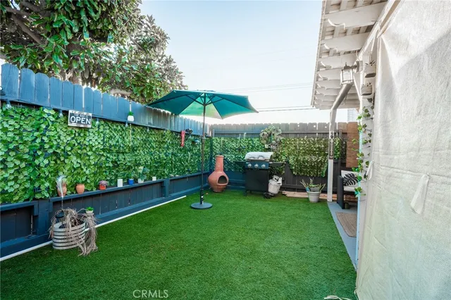 a view of a backyard with a patio and a garden