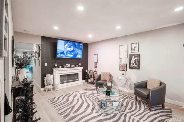 a living room with furniture a fireplace and a flat screen tv