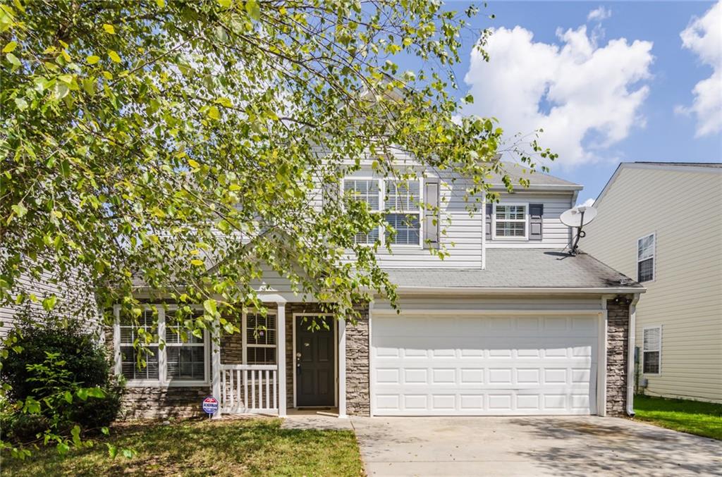3550 Devon Chase Road Atlanta, GA 30349 - Photo 1 of 1 front view of a house with a tree