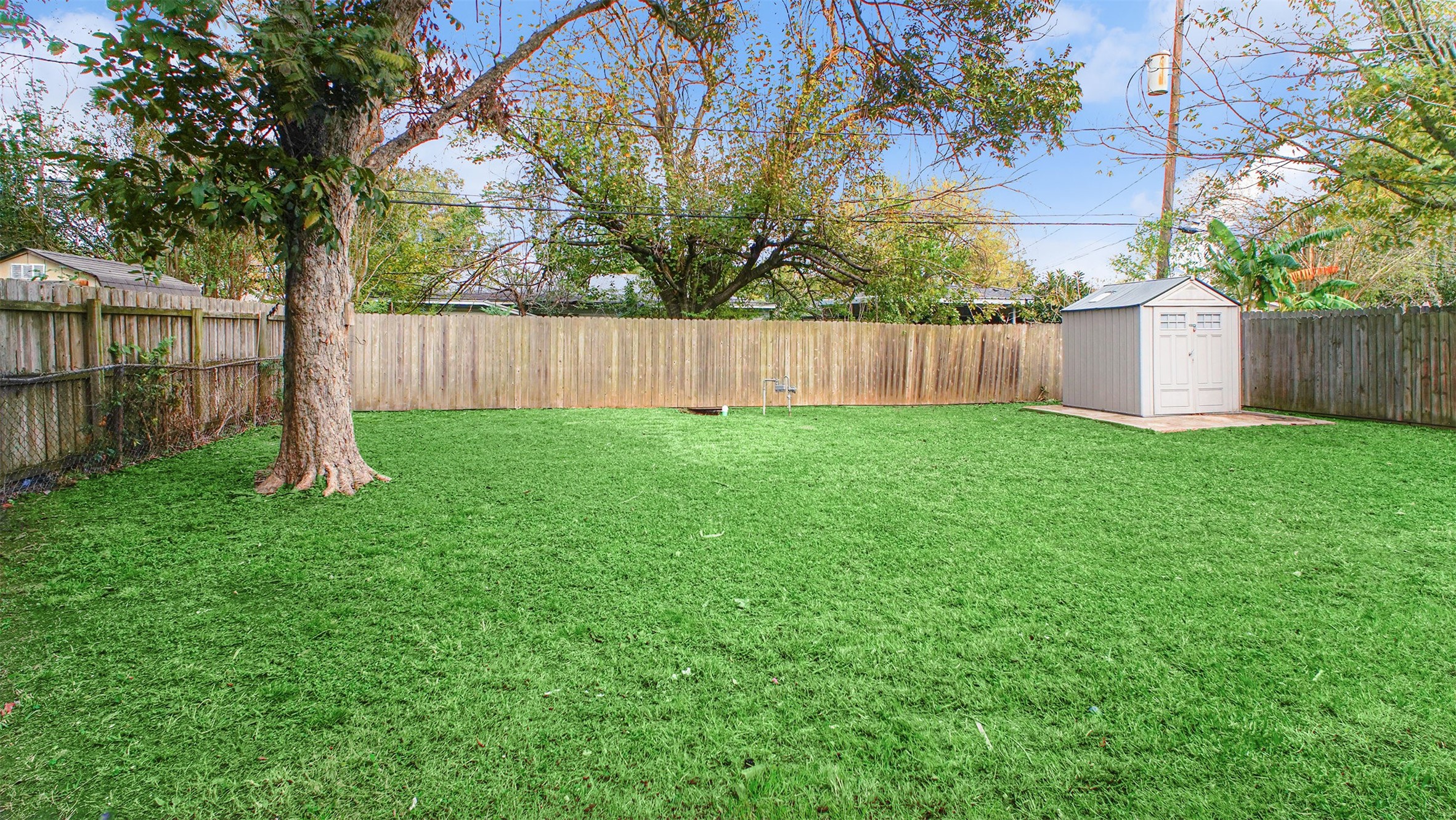 3513 Tanglebriar Drive Pasadena, TX 77503 - Photo 18 of 21 a view of a backyard with a small cabin and wooden fence