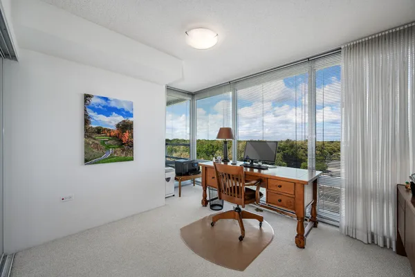 a living room with furniture a lamp and a large window