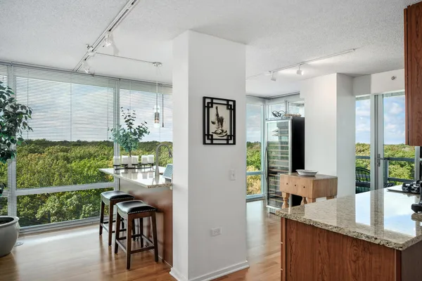 a kitchen with counter top space and dining table