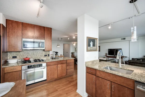a kitchen with a sink stove top oven and microwave