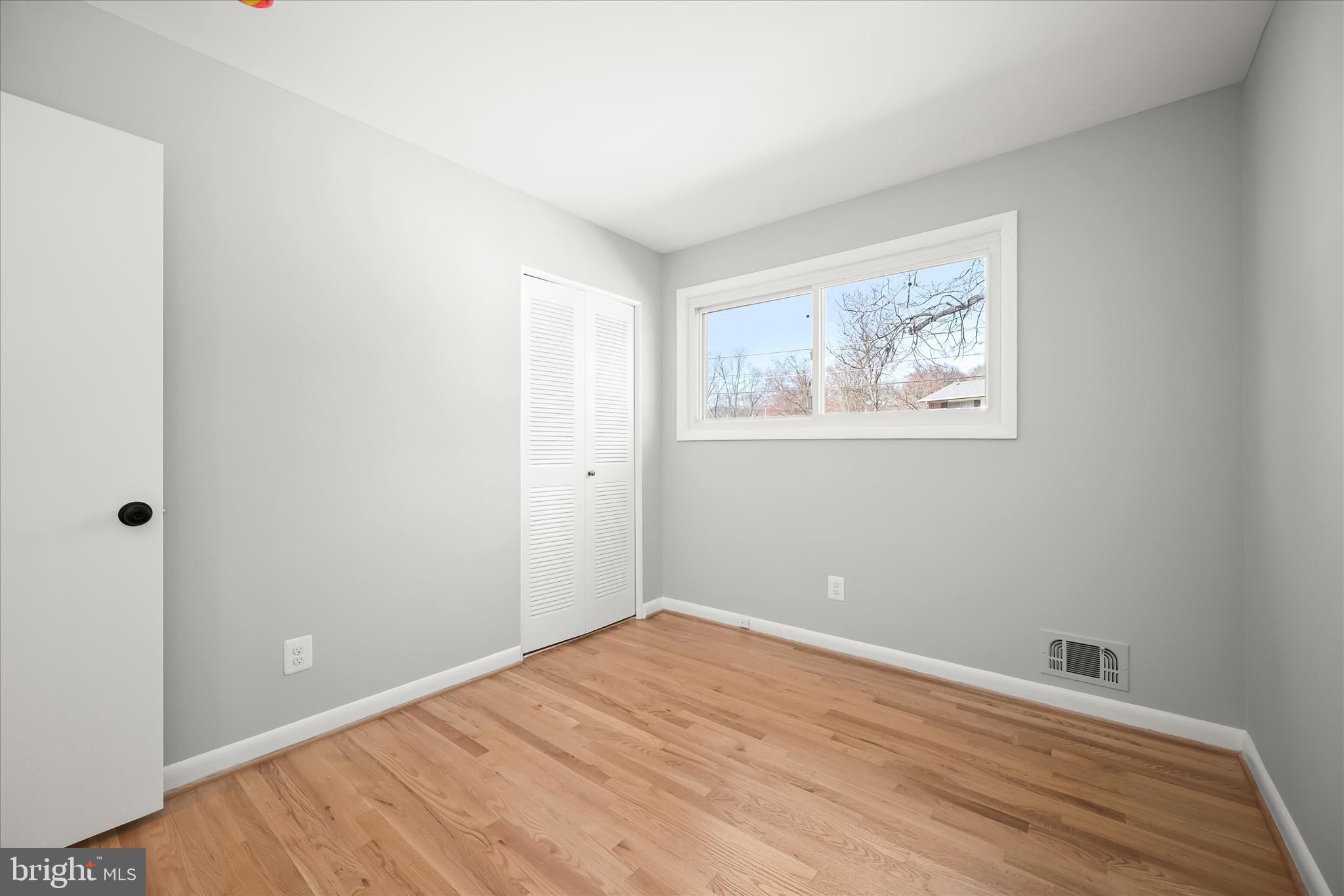 9720 Hedin Drive Silver Spring, MD 20903 - Photo 44 of 79 a view of empty room with wooden floor