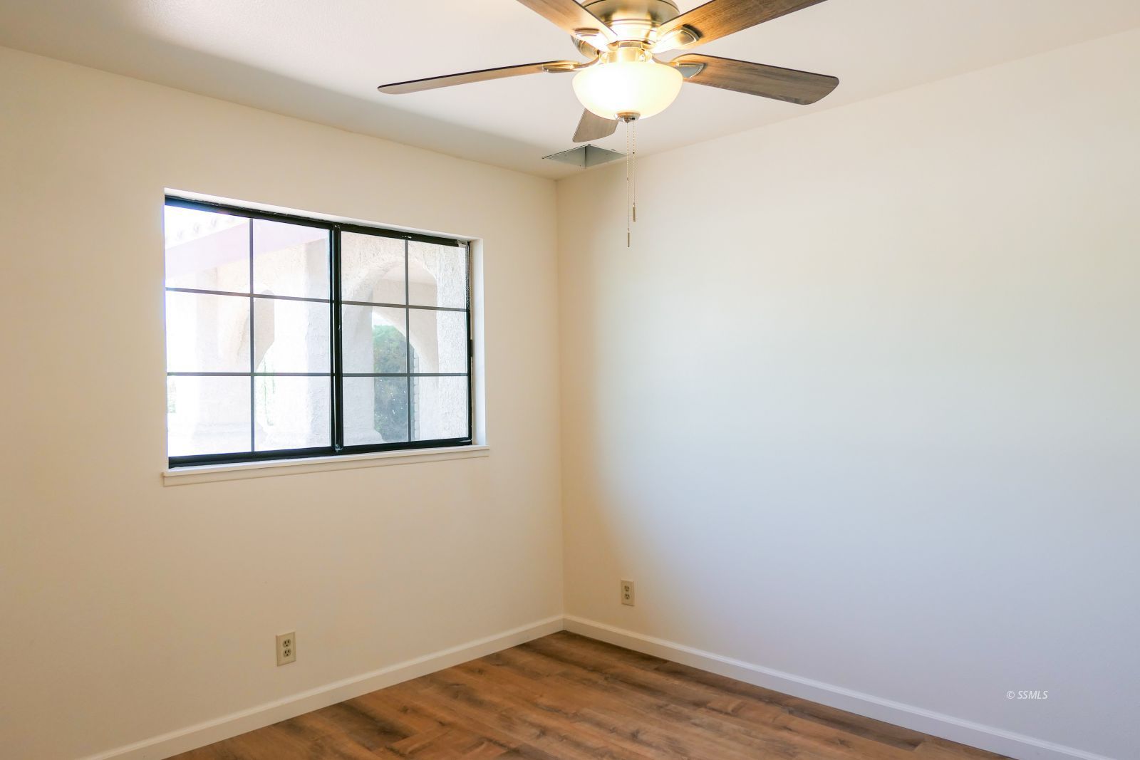 925 Hermosa Avenue Ridgecrest, CA 93555 - Photo 35 of 50 an empty room with a window and wooden floor