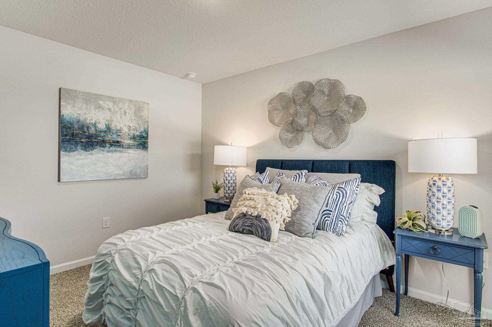 4852 Snipe Road Pace, FL 32571 - Photo 12 of 20 a bedroom with a bed and a painting on the wall