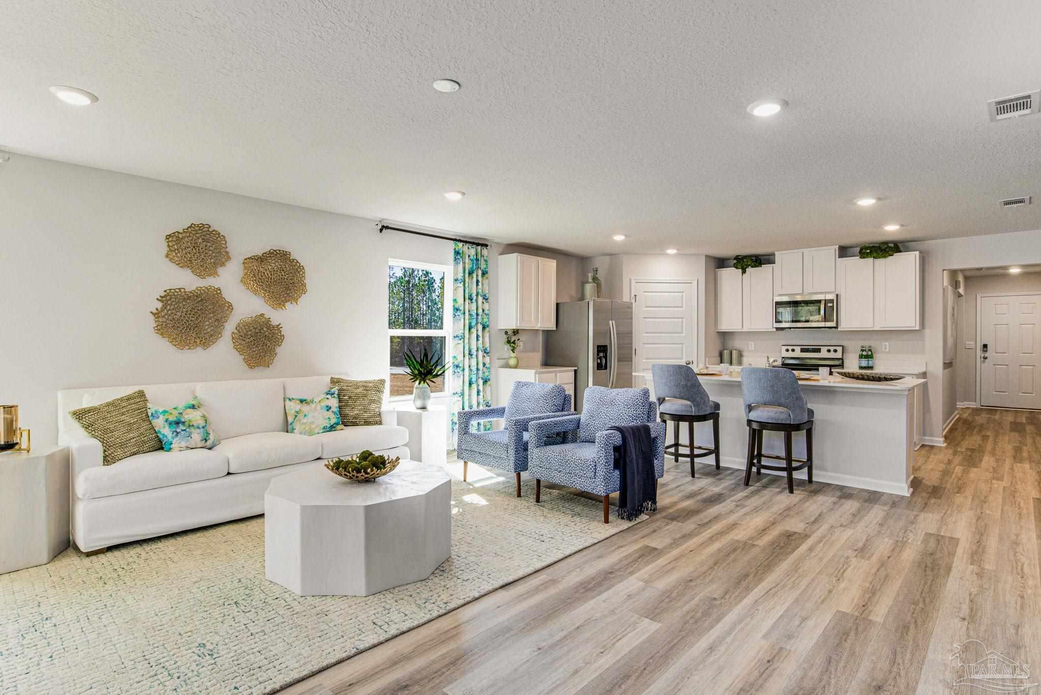 4852 Snipe Road Pace, FL 32571 - Photo 8 of 20 a living room with fireplace furniture and a large window