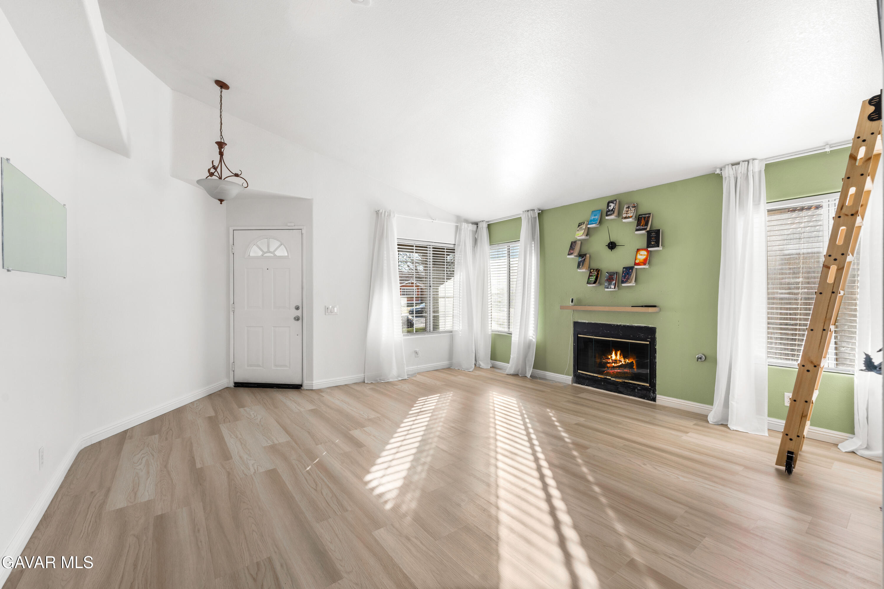 1639 East Kettering Street Lancaster, CA 93535 - Photo 6 of 35 a view of empty room with a fireplace and wooden floor