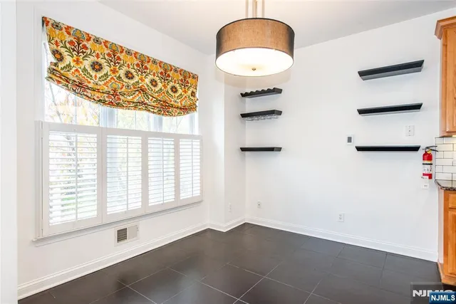 a kitchen with stainless steel appliances granite countertop a sink stove and microwave