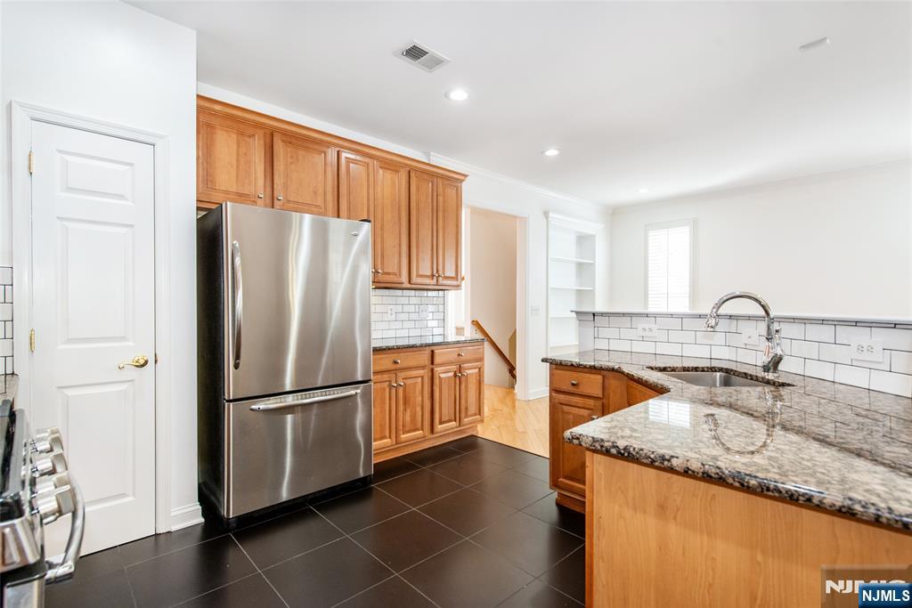 43 South Shore Drive, Unit 81 South Amboy, NJ 08879 - Photo 16 of 30 a kitchen with granite countertop a refrigerator and a sink