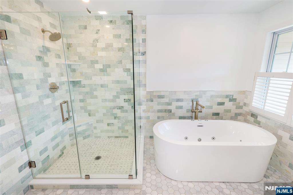 43 South Shore Drive, Unit 81 South Amboy, NJ 08879 - Photo 22 of 30 a white bath tub sitting next to a shower