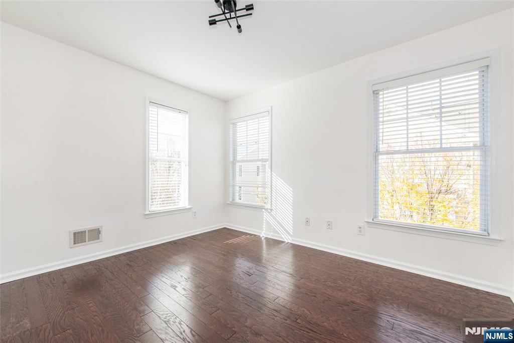 43 South Shore Drive, Unit 81 South Amboy, NJ 08879 - Photo 23 of 30 an empty room with wooden floor and windows