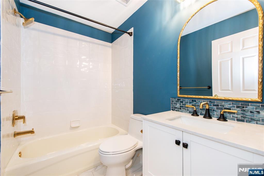 43 South Shore Drive, Unit 81 South Amboy, NJ 08879 - Photo 27 of 30 a bathroom with a bathtub shower sink vanity and toilet