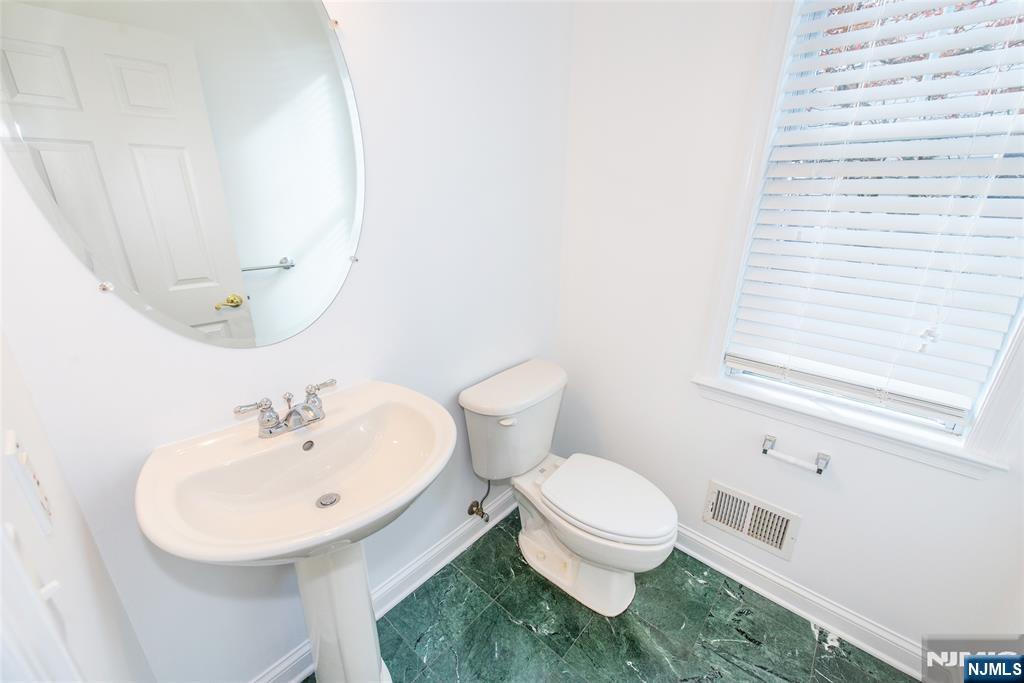 43 South Shore Drive, Unit 81 South Amboy, NJ 08879 - Photo 9 of 30 a bathroom with a sink a toilet and mirror