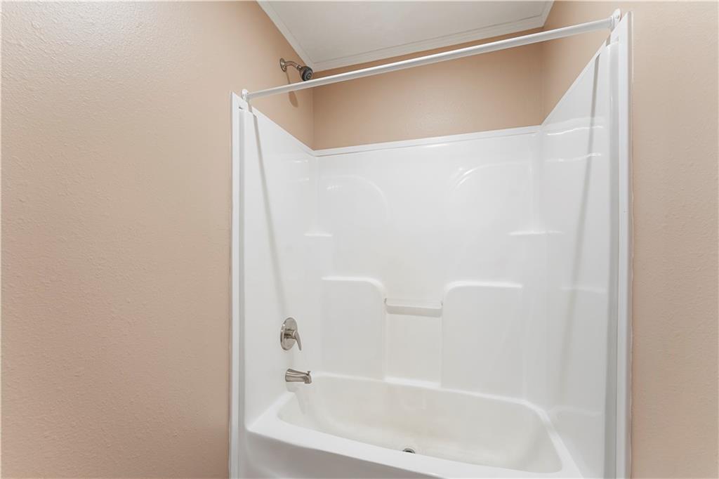 89 Ridge Road Seale, AL 36875 - Photo 31 of 46 White acrylic tub and shower combination with chrome fixtures