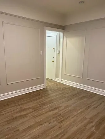 a view of wooden floor and brick walls