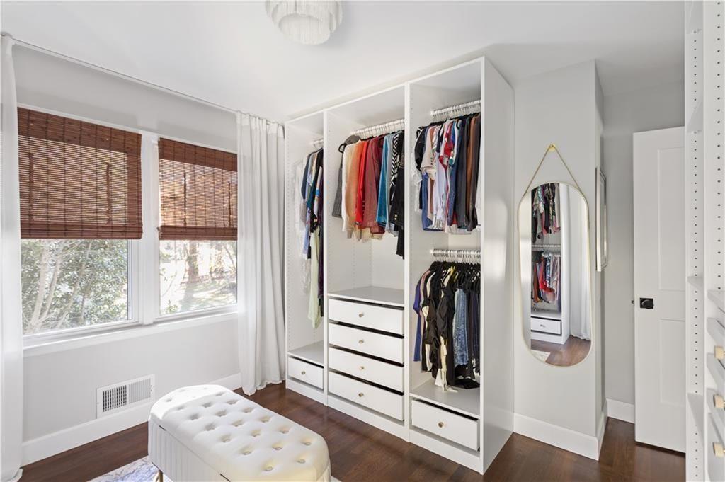 5925 Old Bill Cook Road Atlanta, GA 30349 - Photo 14 of 49 a view of walk in closet with clothes and shoes