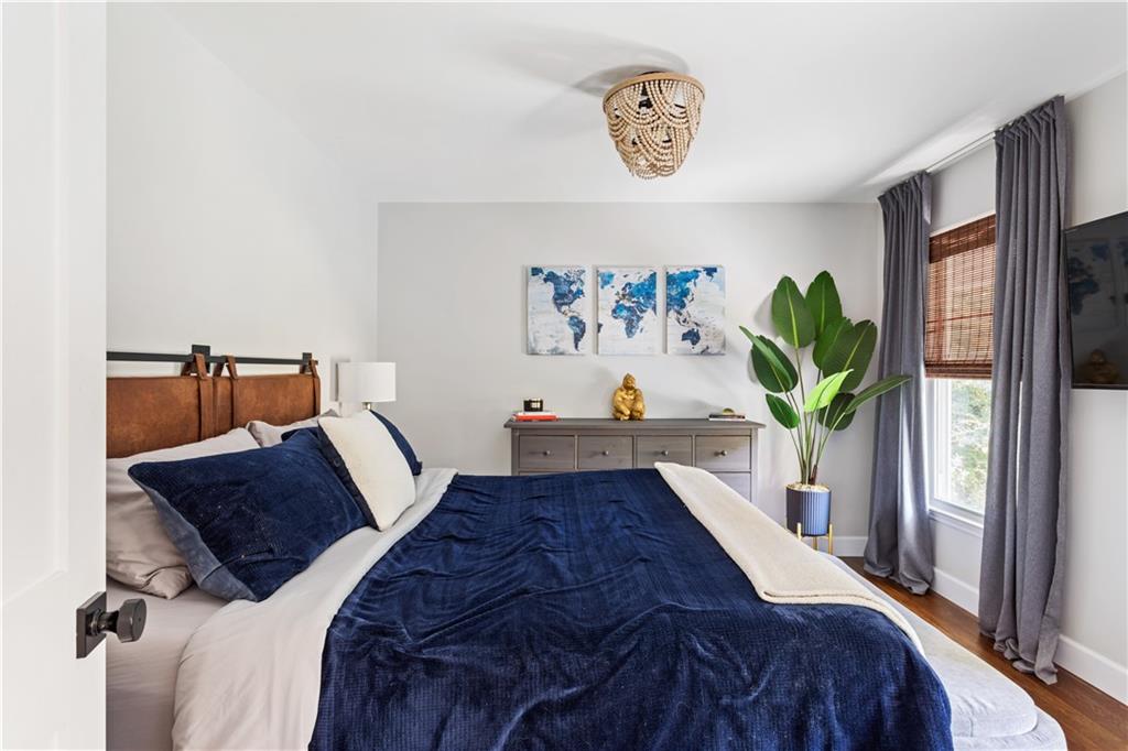 5925 Old Bill Cook Road Atlanta, GA 30349 - Photo 17 of 49 a bed sitting in a bedroom next to a window