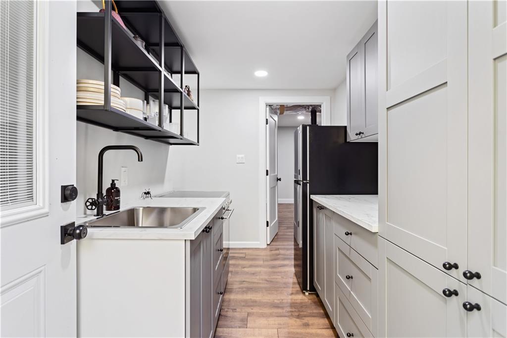 5925 Old Bill Cook Road Atlanta, GA 30349 - Photo 27 of 49 a kitchen with stainless steel appliances a sink and a refrigerator