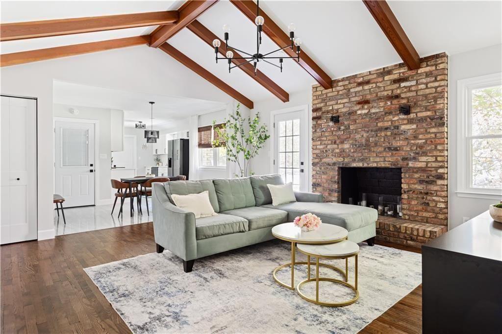 5925 Old Bill Cook Road Atlanta, GA 30349 - Photo 8 of 49 a living room with furniture a fireplace and a table