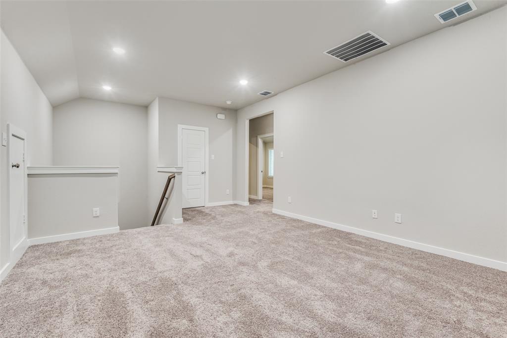 2544 Rambling Road Celina, TX 75009 - Photo 17 of 25 Spare room featuring vaulted ceiling and carpet flooring