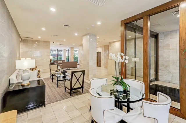 a dining room filled chandelier and kitchen view