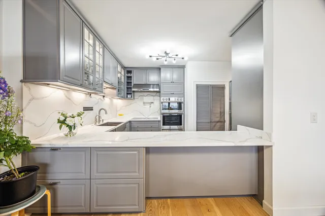 a kitchen with kitchen island a sink stainless steel appliances and cabinets