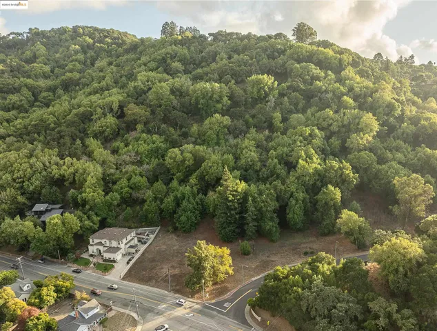 an aerial view of a house with a yard