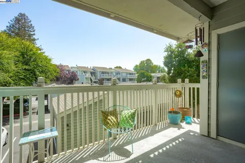 a balcony with trees in front of it