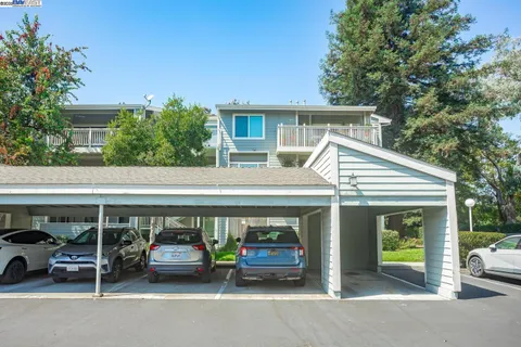 a view of building with car parked