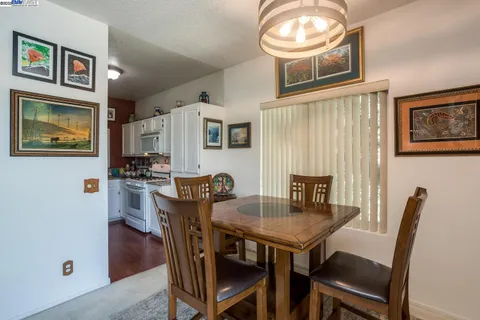 a view of a dining room with furniture and a chandelier