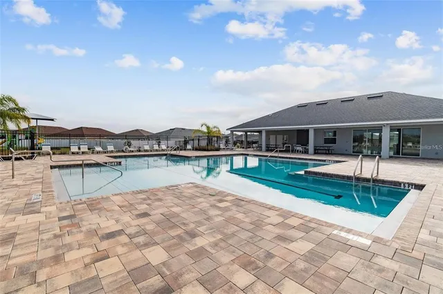 a view of house with yard outdoor seating and water view