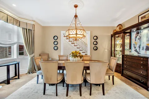 a dining room with furniture a chandelier and wooden floor