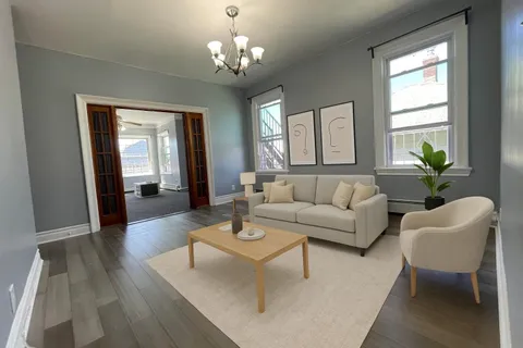 a living room with furniture and a chandelier