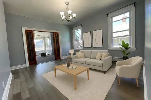 a living room with furniture and a chandelier