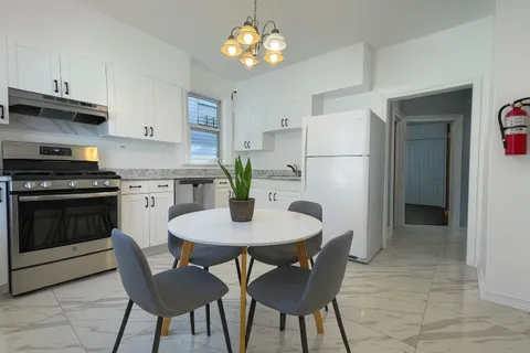 an empty room with windows and ceiling fan