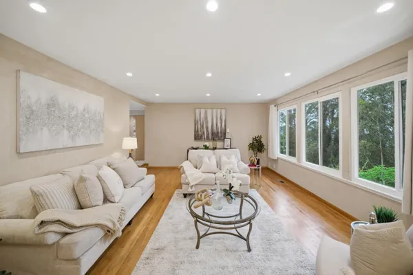 a living room with furniture and wooden floor