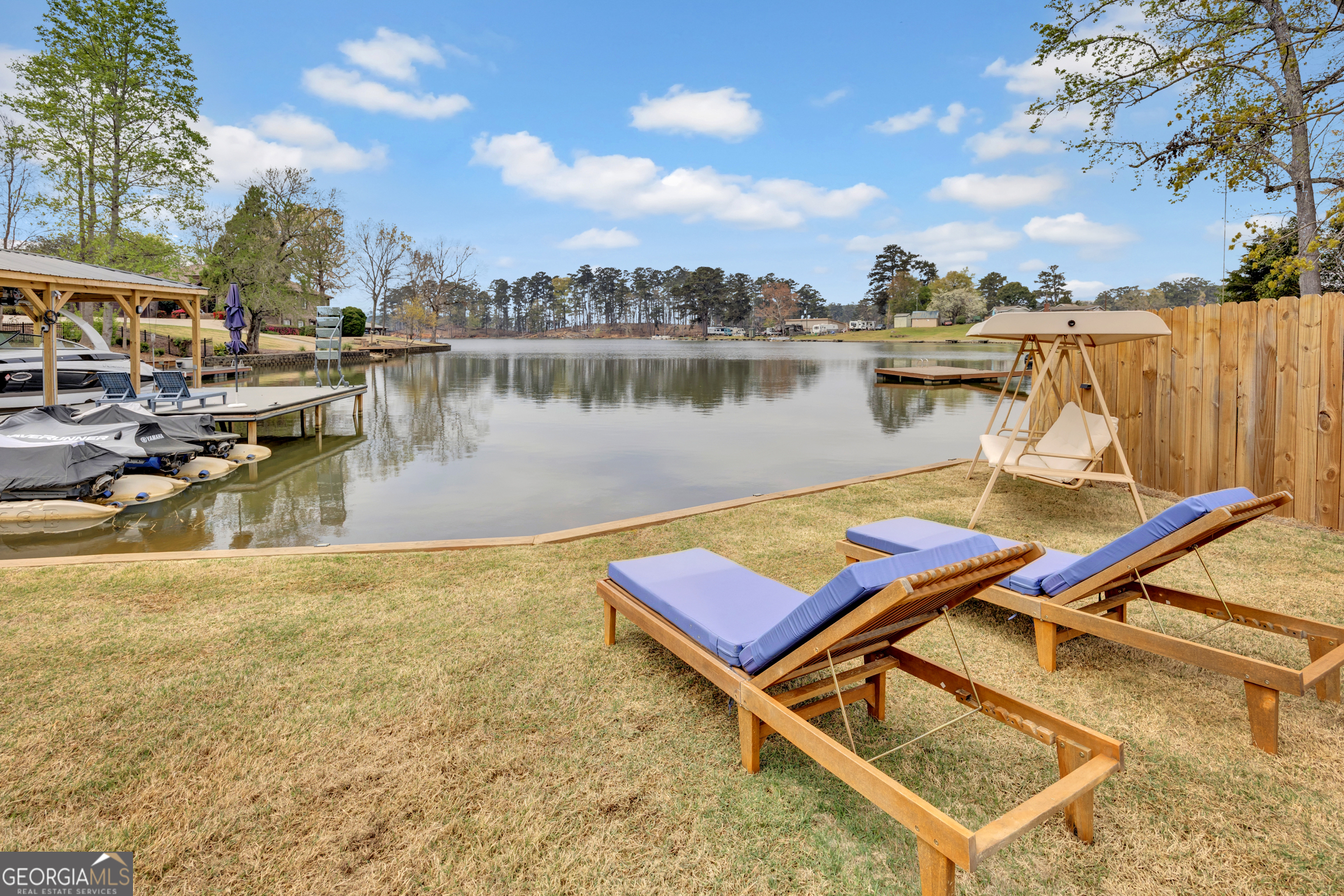 8900 Jackson Lake Road Monticello, GA 31064 - Photo 15 of 72 a view of a lake with lawn chairs