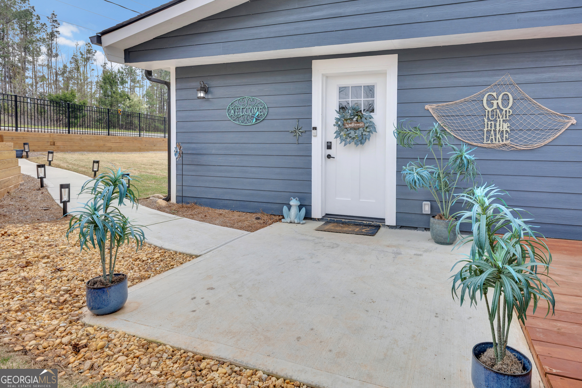 8900 Jackson Lake Road Monticello, GA 31064 - Photo 20 of 72 a potted plant sitting in front of a house