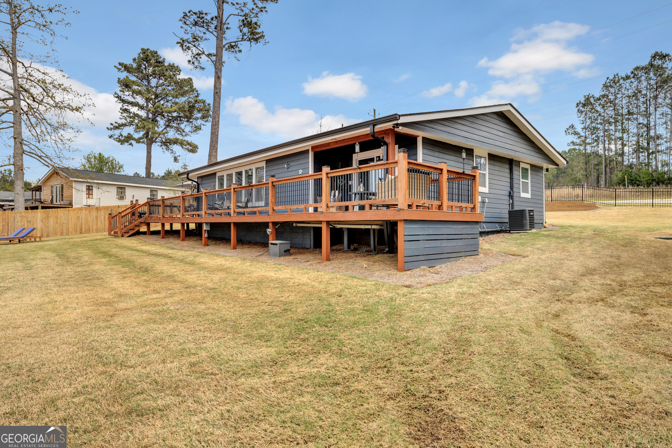 8900 Jackson Lake Road Monticello, GA 31064 - Photo 5 of 72 a front view of a house with a yard and balcony
