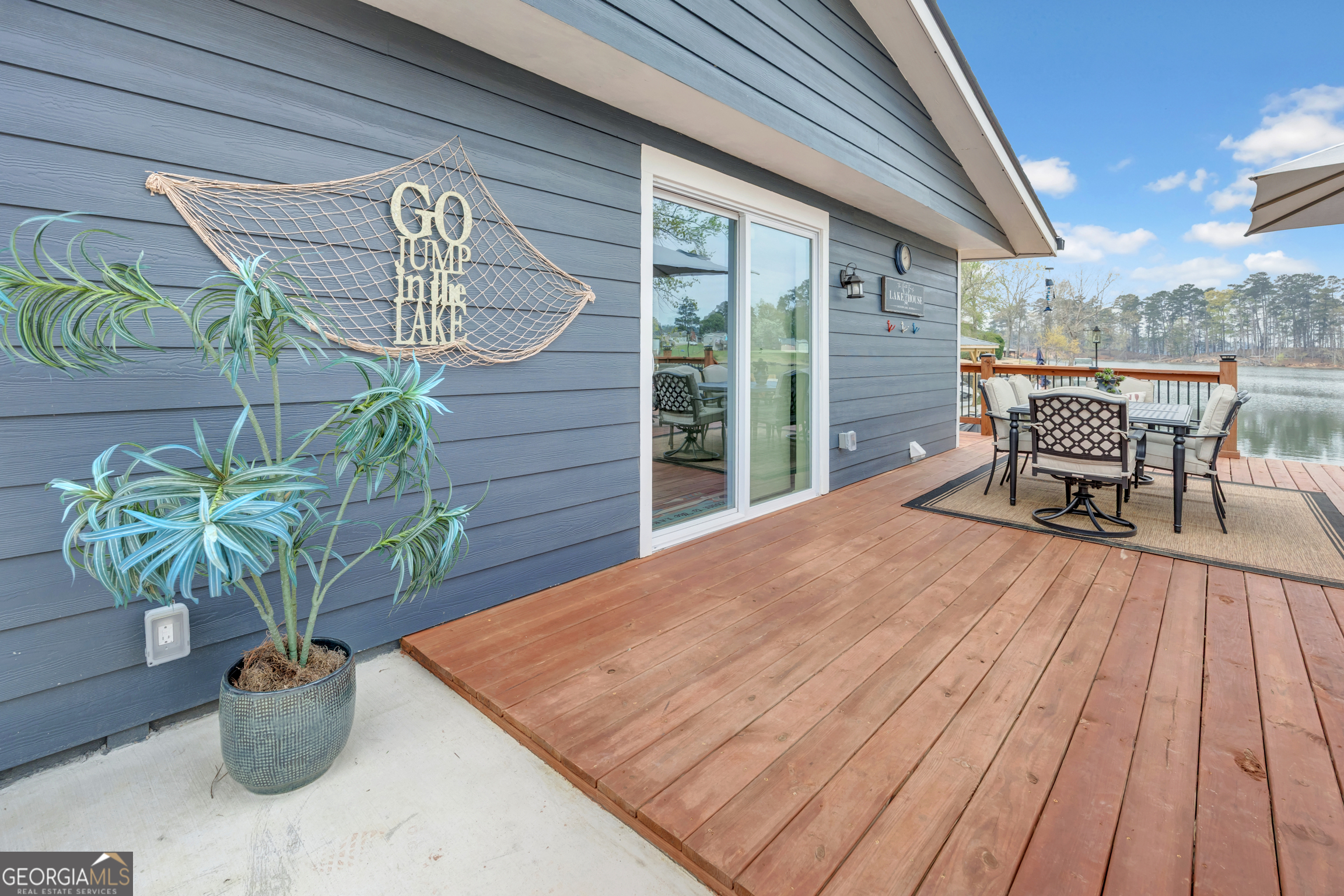 8900 Jackson Lake Road Monticello, GA 31064 - Photo 51 of 72 a view of a deck with table and chairs with wooden floor