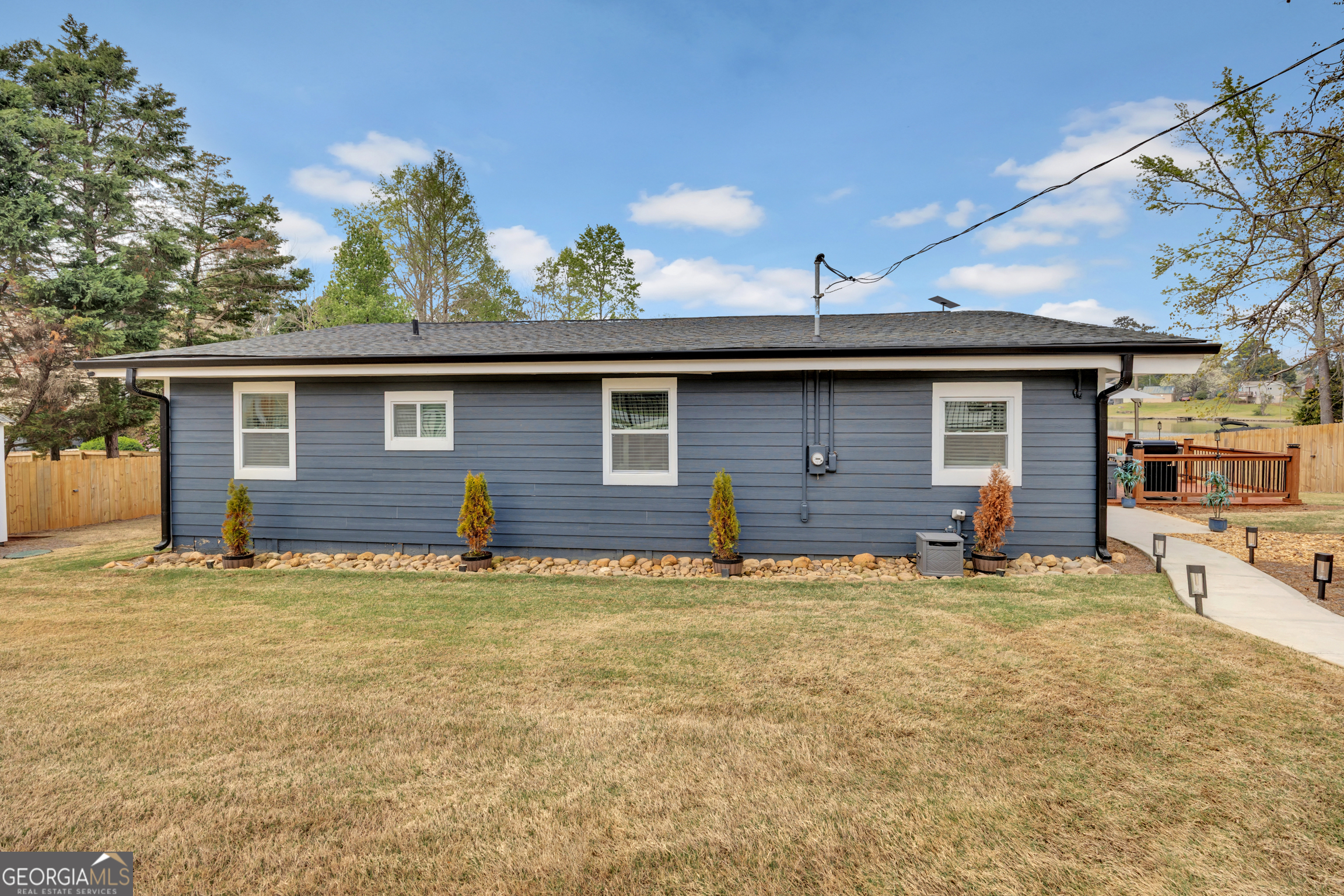 8900 Jackson Lake Road Monticello, GA 31064 - Photo 53 of 72 a house with large trees in the background