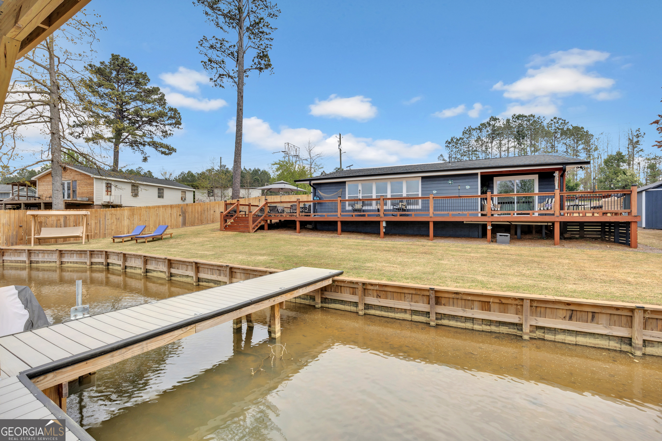 8900 Jackson Lake Road Monticello, GA 31064 - Photo 62 of 72 a view of a swimming pool with outdoor seating