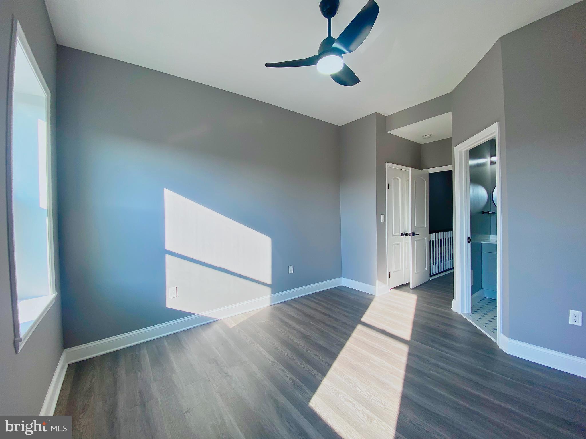 1604 Cliftview Avenue Baltimore, MD 21213 - Photo 9 of 36 wooden floor in an empty room with a window