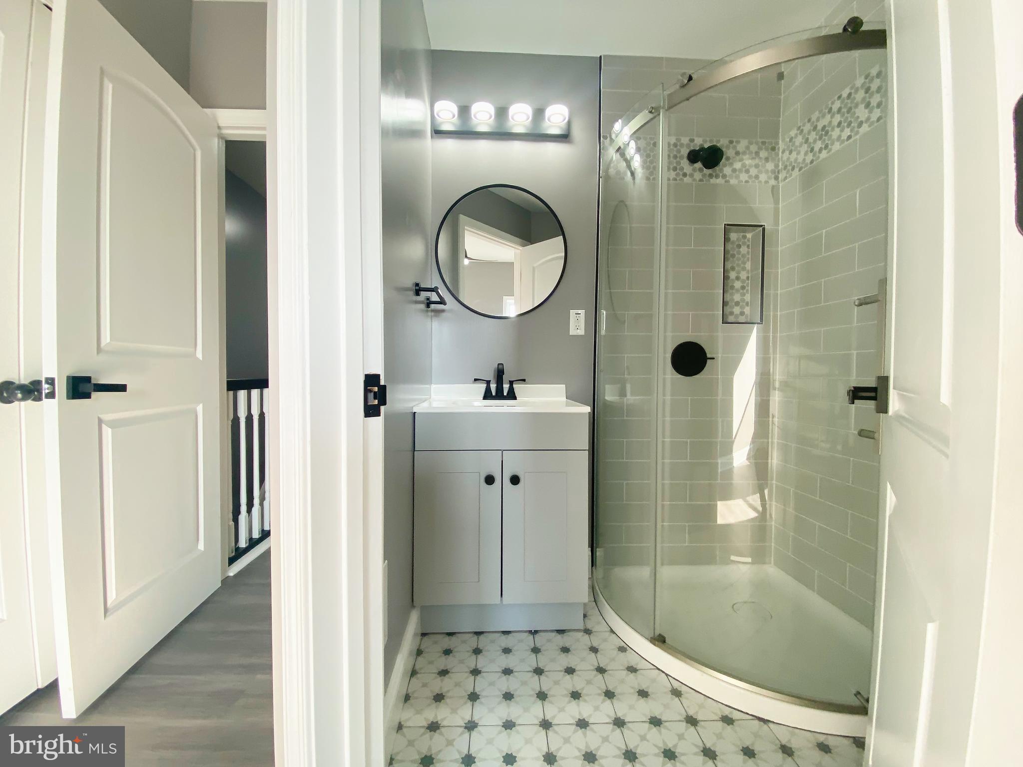 1604 Cliftview Avenue Baltimore, MD 21213 - Photo 14 of 36 a bathroom with a sink a shower and a mirror